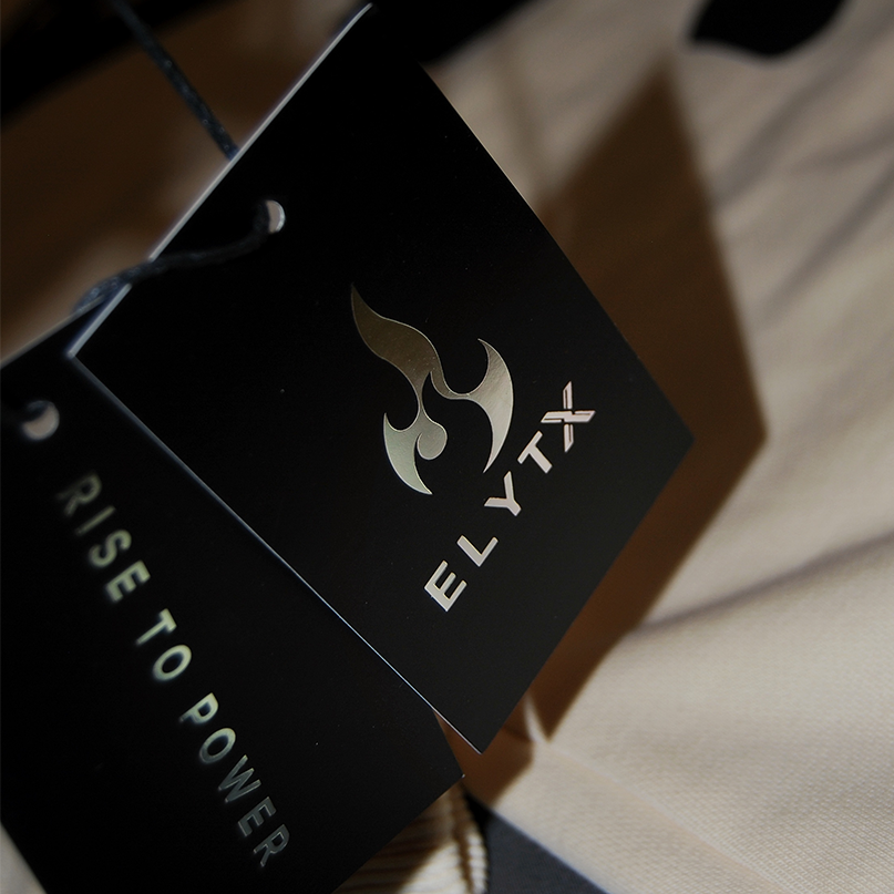 ELYTX swing tags showing the flame logo and the words Rise To Power